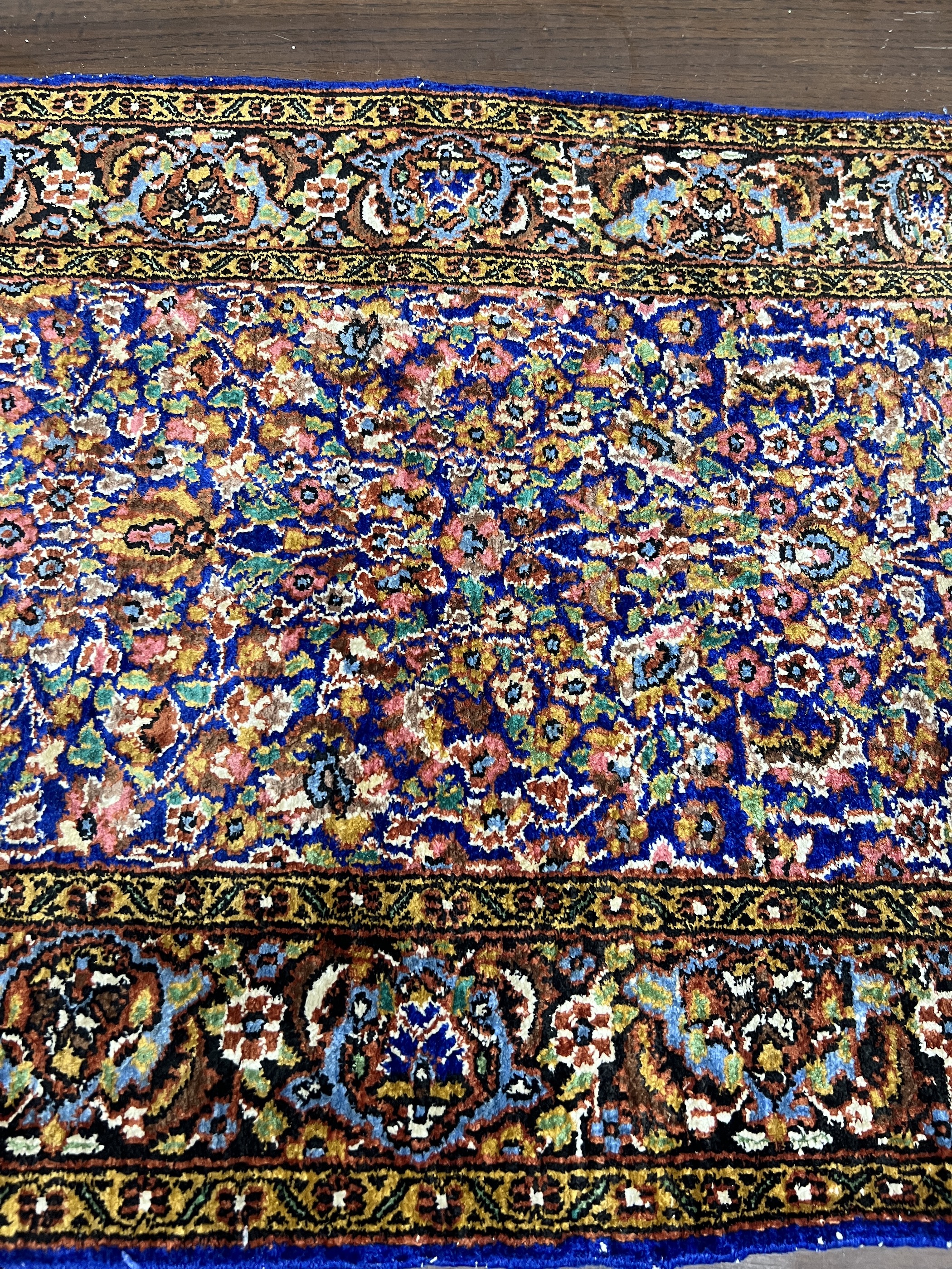 A North West Persian part silk blue ground rug, 89cm x 58cm